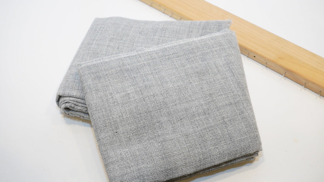 Grey primary tufting cloth stretched for rug making