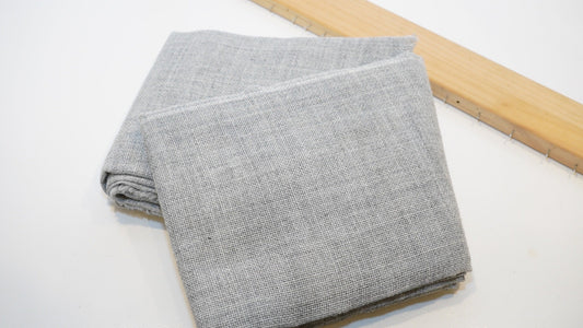Grey primary tufting cloth stretched for rug making