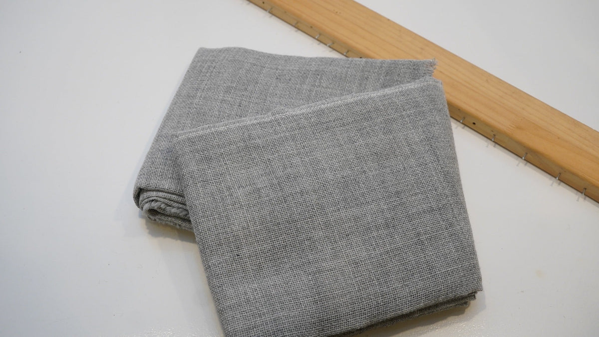 Grey primary tufting cloth showing its woven texture